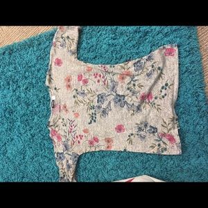 It’s a grey shirt with flowers on it